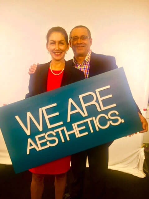 Heather Furnas, MD and Francisco Canales, MD holding sign with ASAPS slogan, 