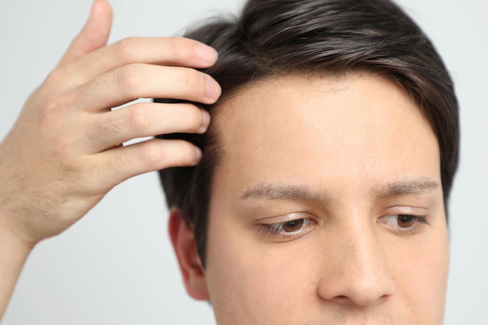 Man Touching Hair Photo